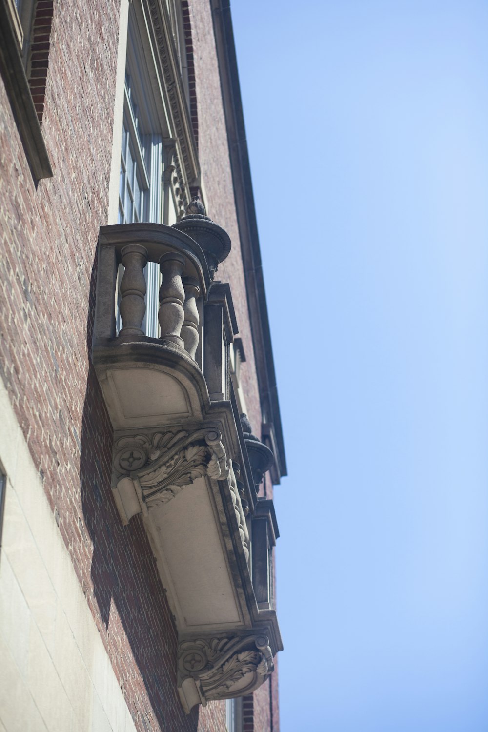 a tall brick building with a clock on it's side