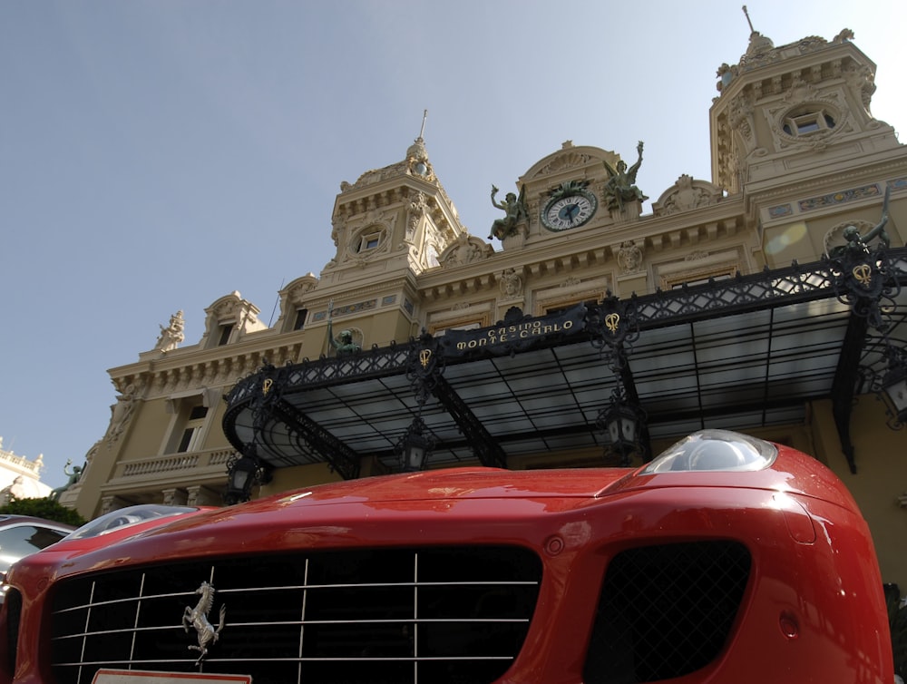 a red car parked in front of a building