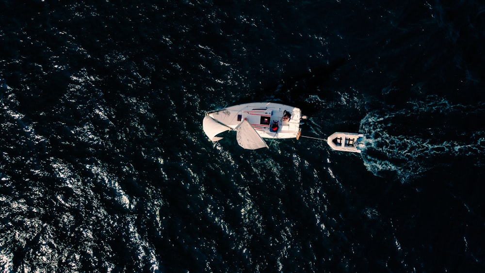 un petit bateau blanc flottant au-dessus d’un plan d’eau