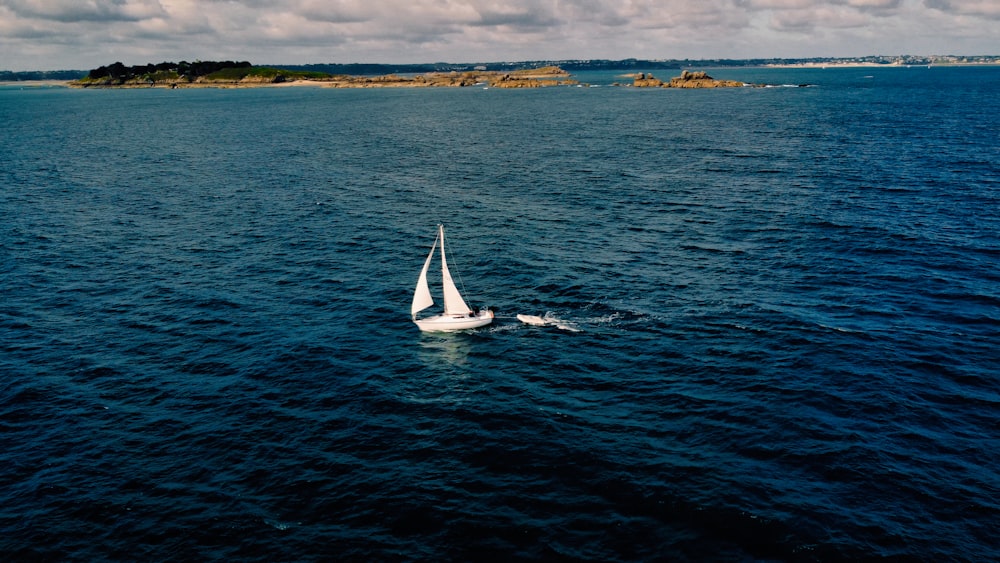 a sailboat in the middle of a body of water