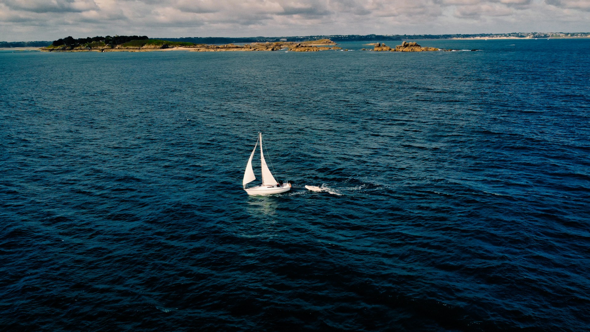 a sailboat in the middle of a body of water