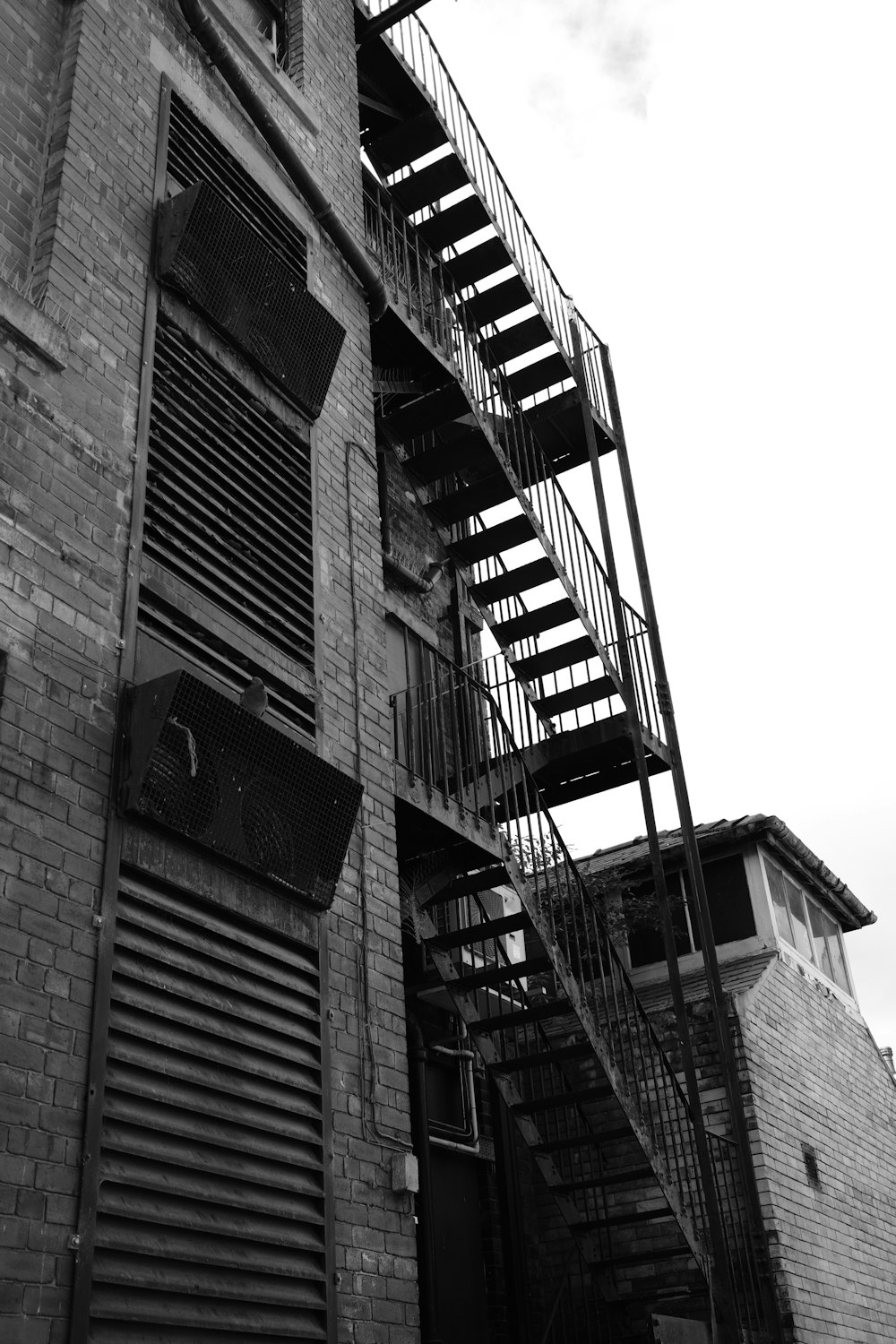 a black and white photo of a fire escape