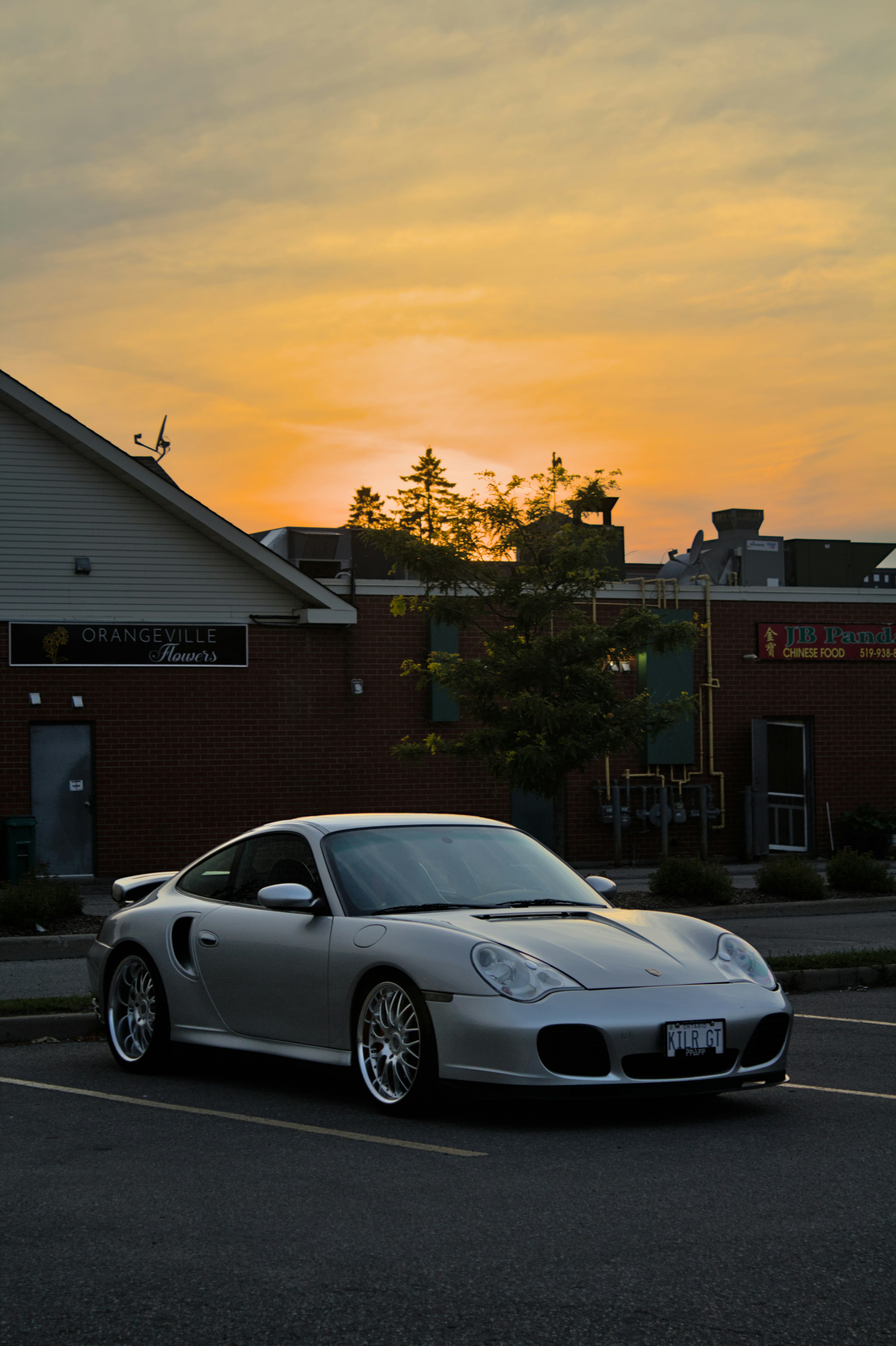 a silver sports car parked in a parking lot