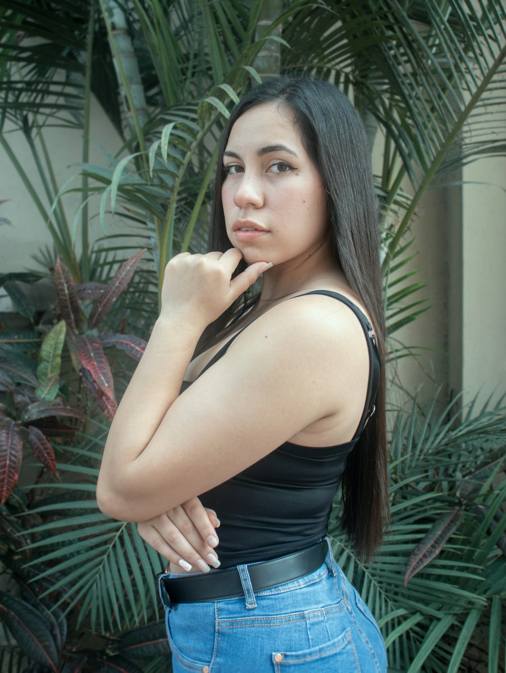 a woman in a black top is posing for a picture