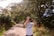 A serene scene of a birdwatcher with binoculars, surrounded by vibrant trees and birds.