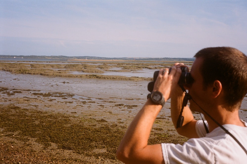 a man taking a picture of a body of water