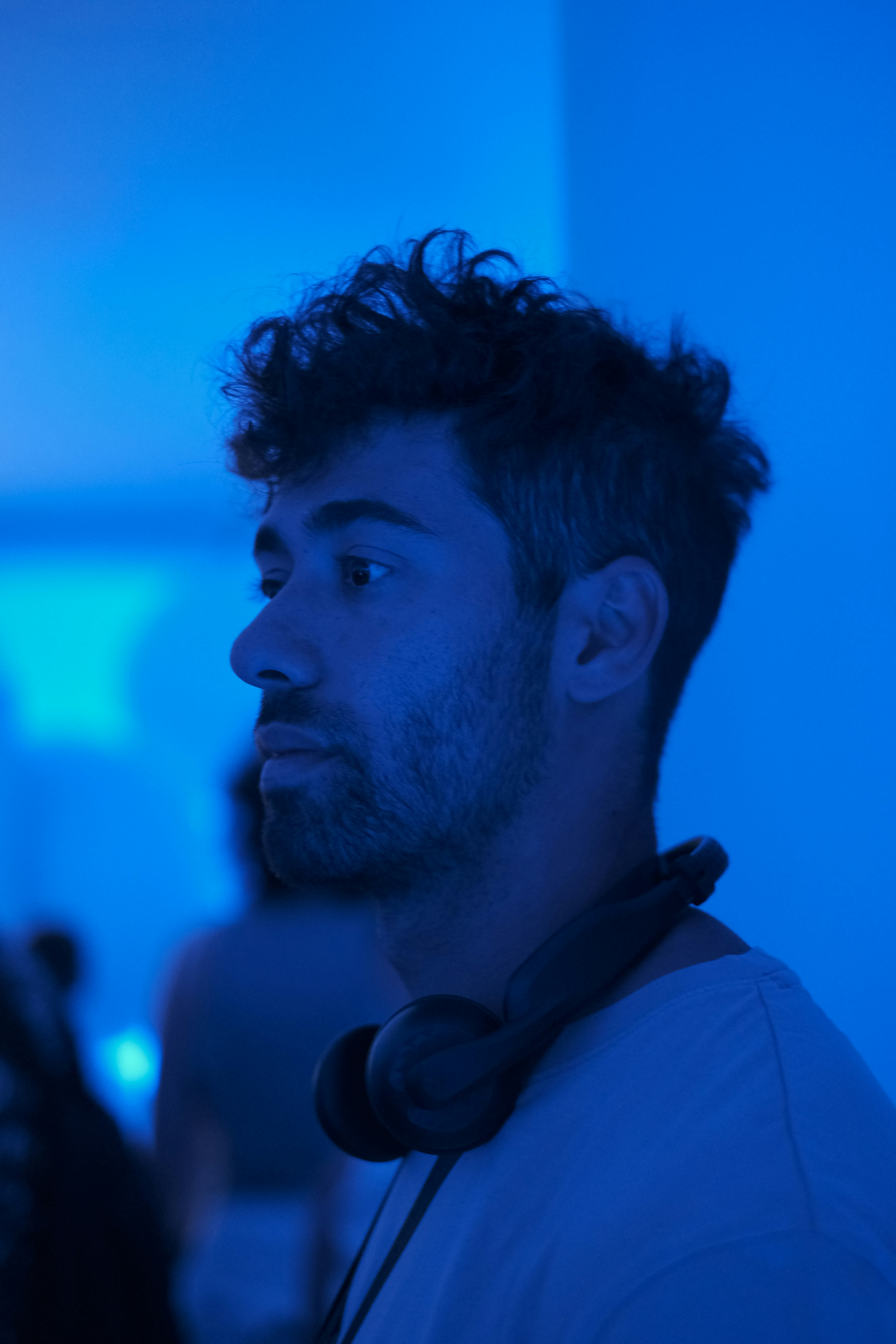 a man standing in a room with headphones on