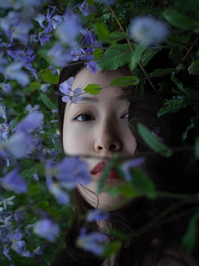 A warm portrait of a smiling woman in a peaceful garden, embodying calm and transformation.