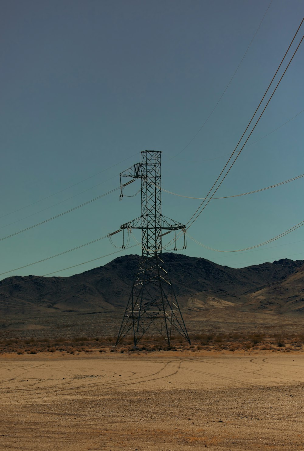 a tall metal tower sitting in the middle of a desert