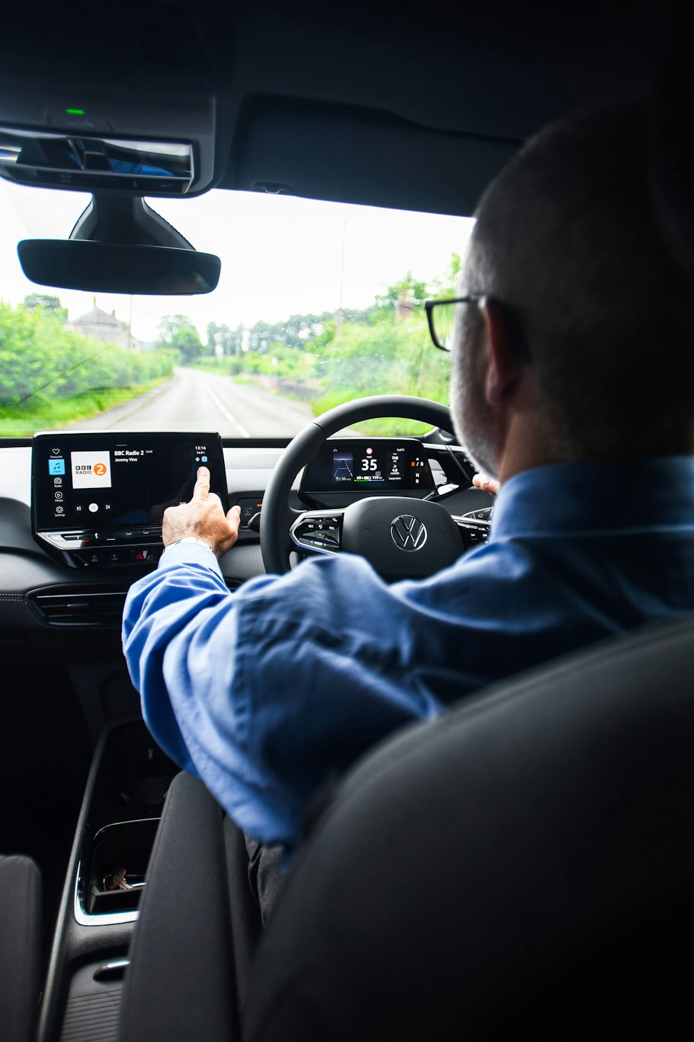 a man driving a car on a road