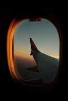 a view of the wing of an airplane through a window