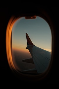 a view of the wing of an airplane through a window