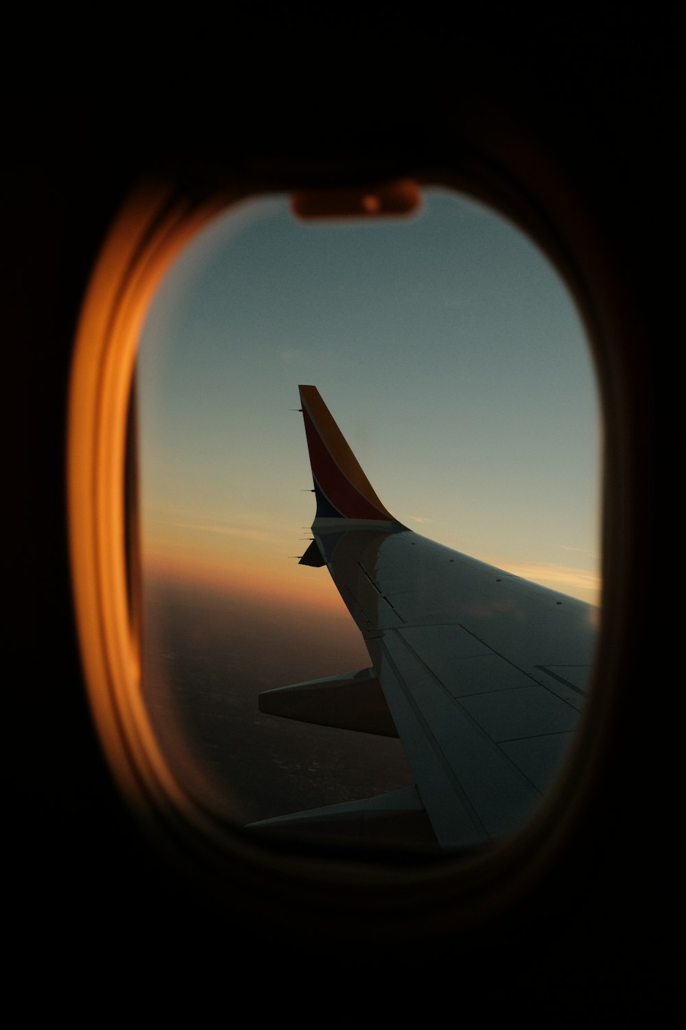 a view of the wing of an airplane through a window