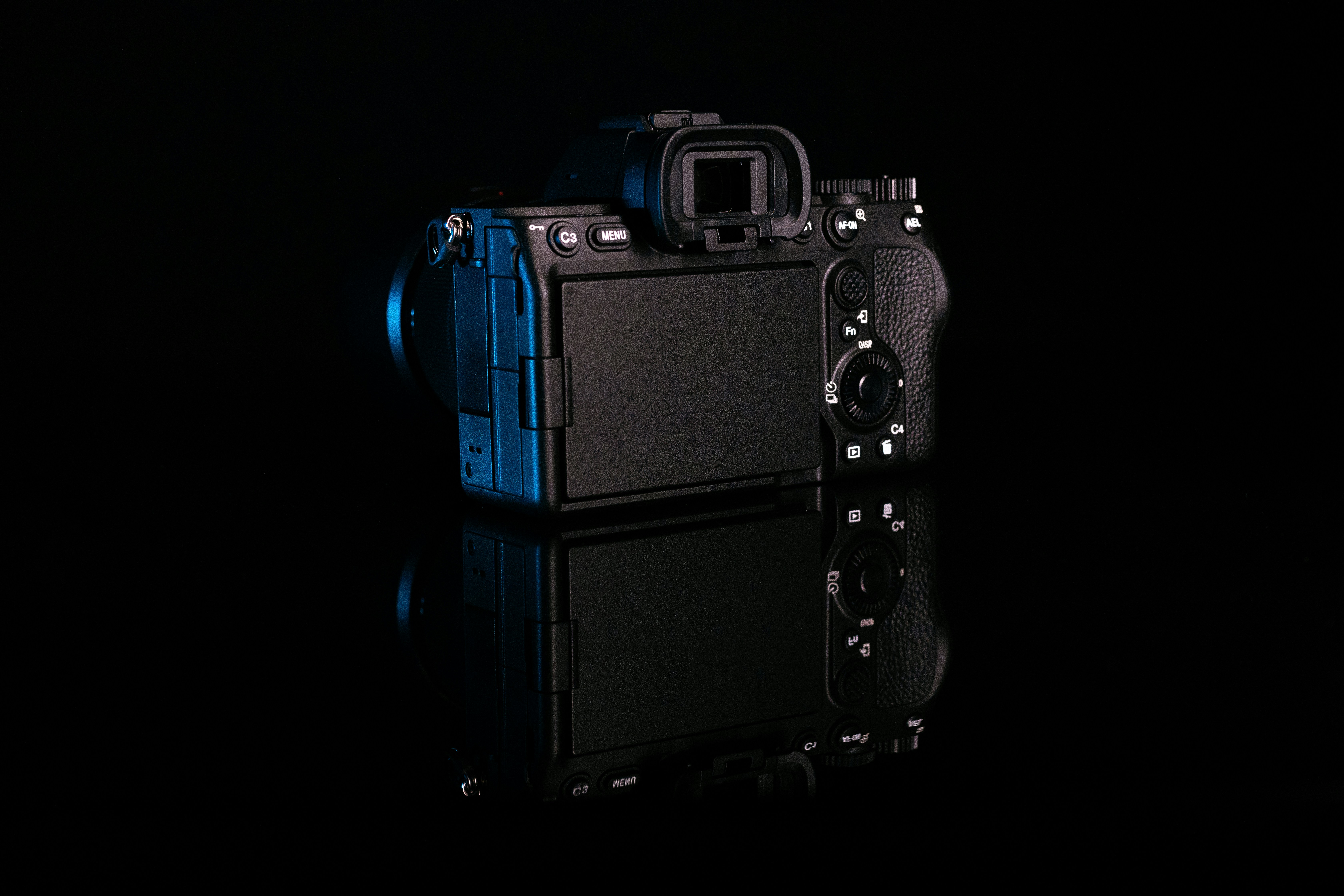 a black and blue camera sitting on top of a table