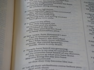 A close-up of a page from an open book, showing printed text in both prose and numbered verses. The text seems to be focused on themes of distress, seeking divine guidance, and historical or religious content.
