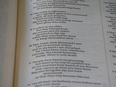 A close-up of a page from an open book, showing printed text in both prose and numbered verses. The text seems to be focused on themes of distress, seeking divine guidance, and historical or religious content.