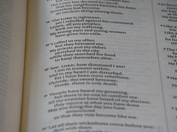A close-up of a page from an open book, showing printed text in both prose and numbered verses. The text seems to be focused on themes of distress, seeking divine guidance, and historical or religious content.