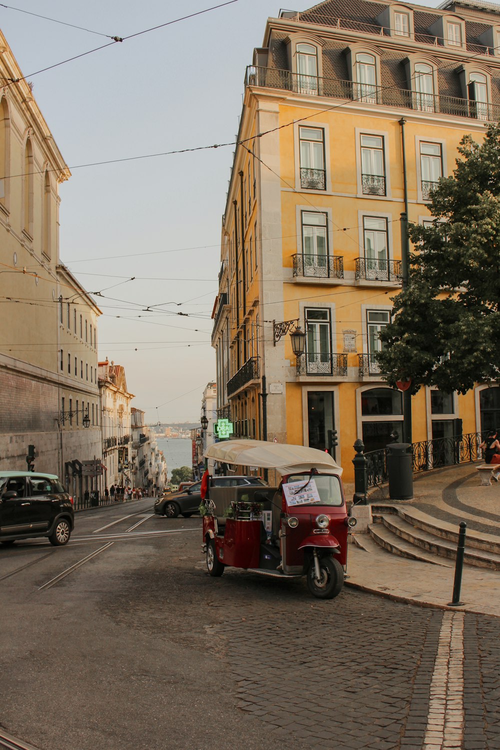 a street scene with an old car and a van