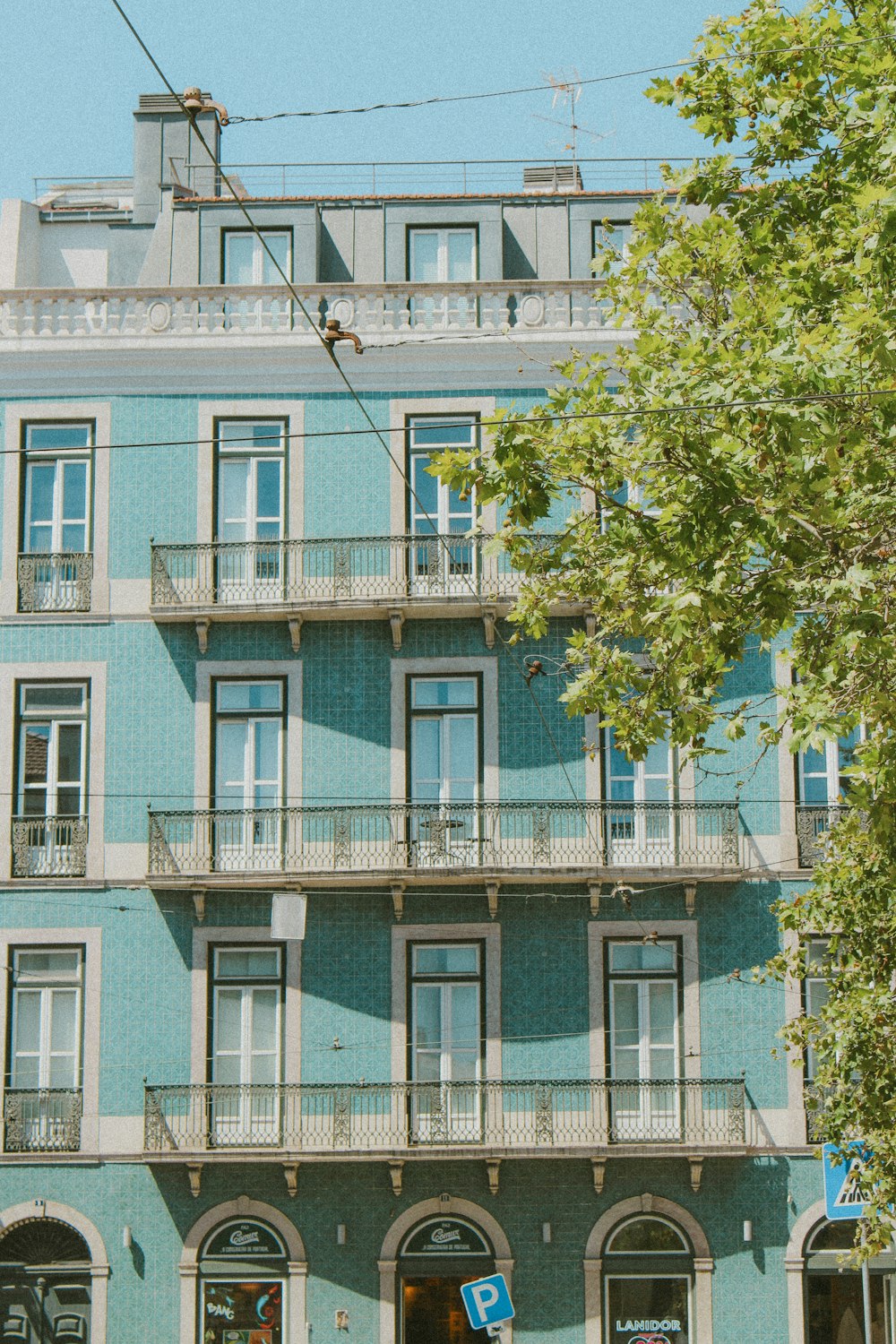 a blue building with balconies and balconies on the balconies