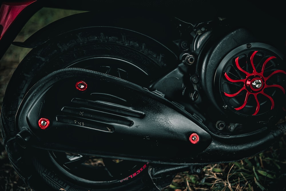 a close up of a motor bike with red spokes