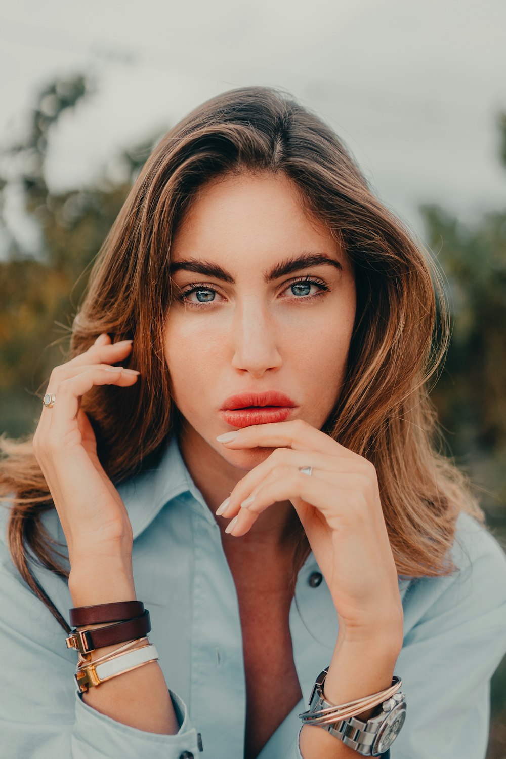 a woman in a blue shirt posing for a picture