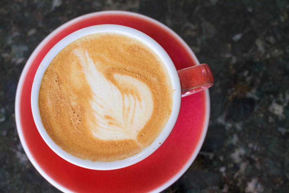 a cup of coffee on a saucer on a table