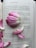 A book page is open, displaying text alongside pink and white flower petals strategically placed on its surface. The text seems to be from a narrative, possibly a novel, with conversations and expressive language visible. The petals add an element of delicacy and elegance to the scene.