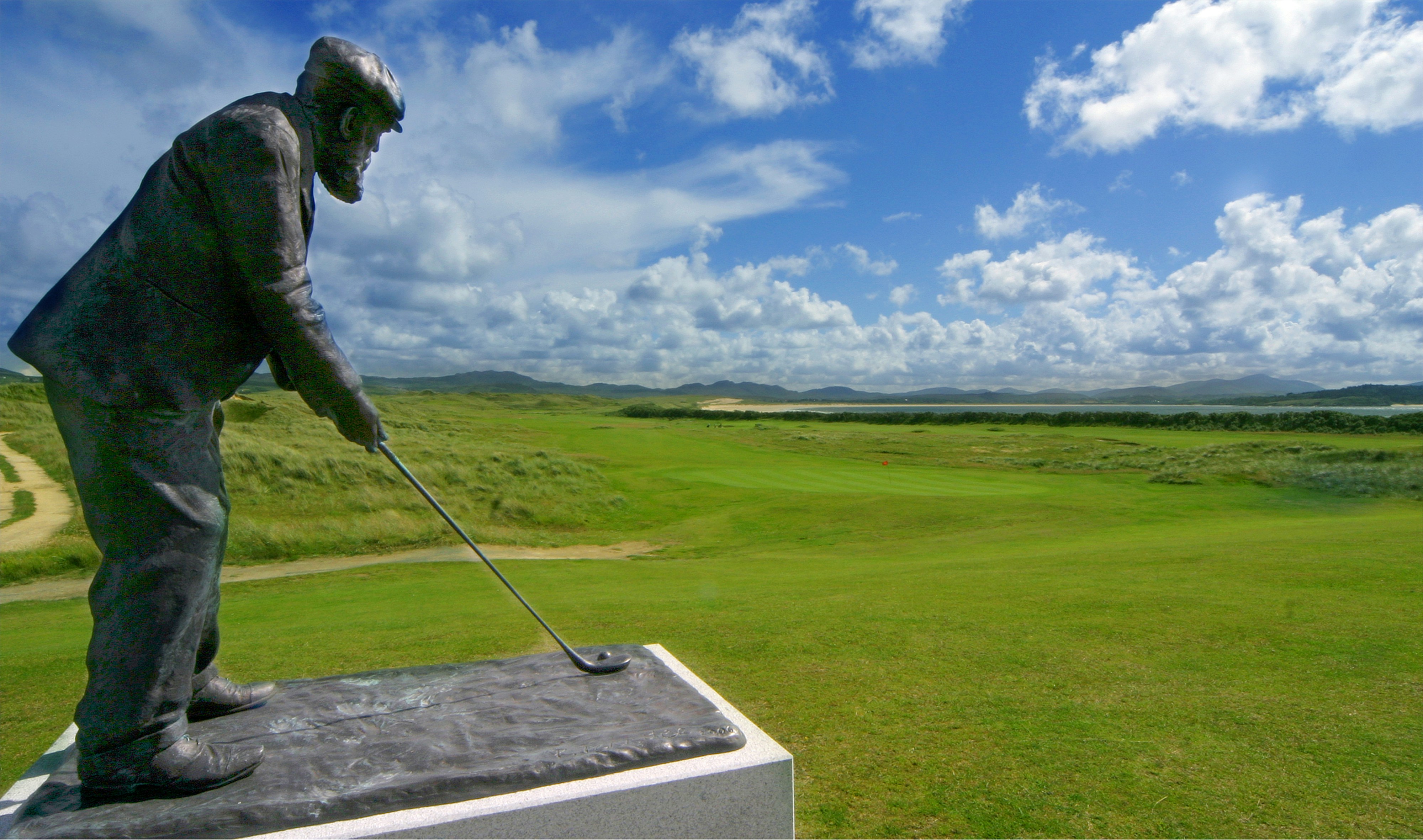 a statue of a man holding a golf club