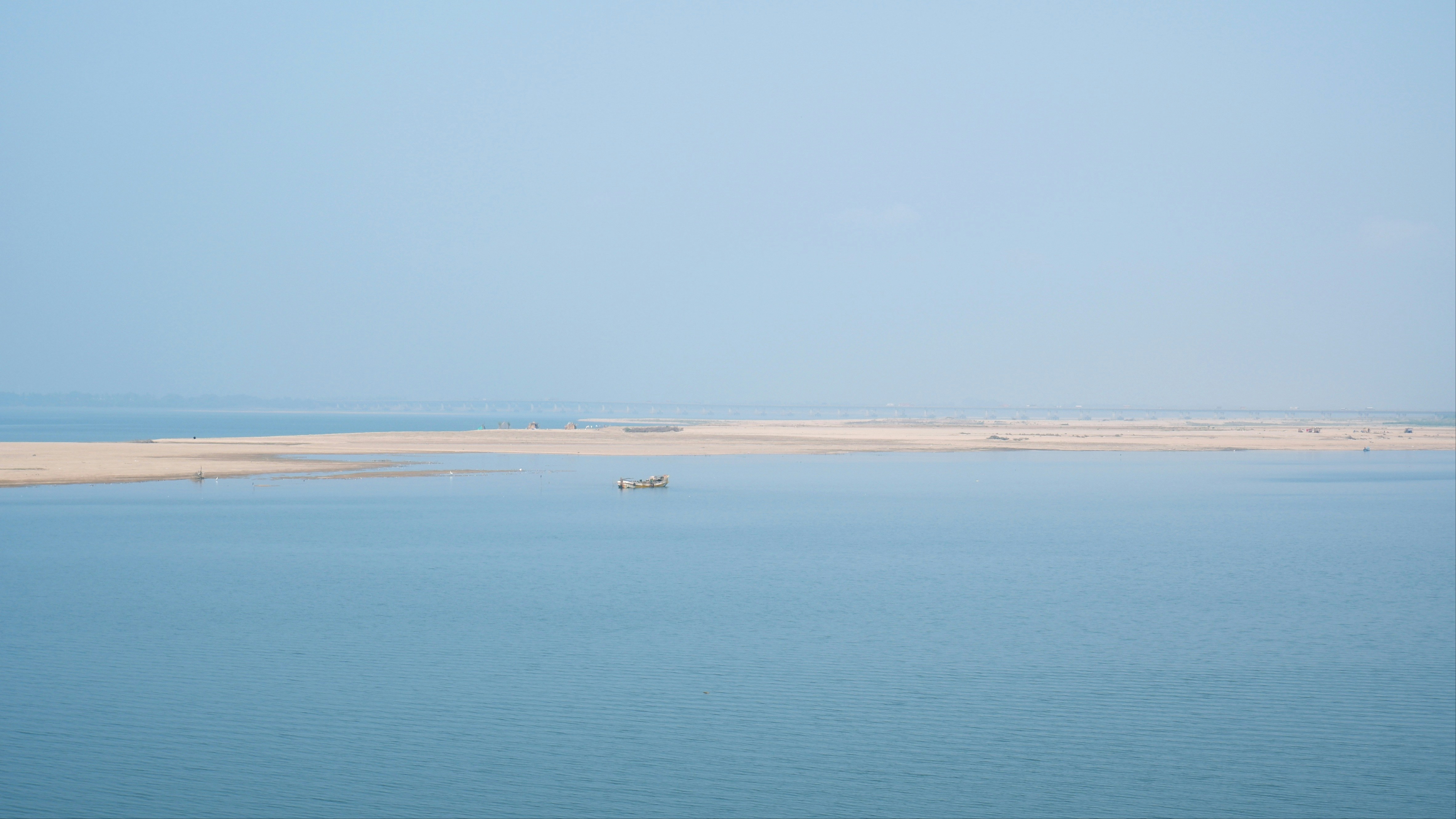 a small boat floating on top of a large body of water