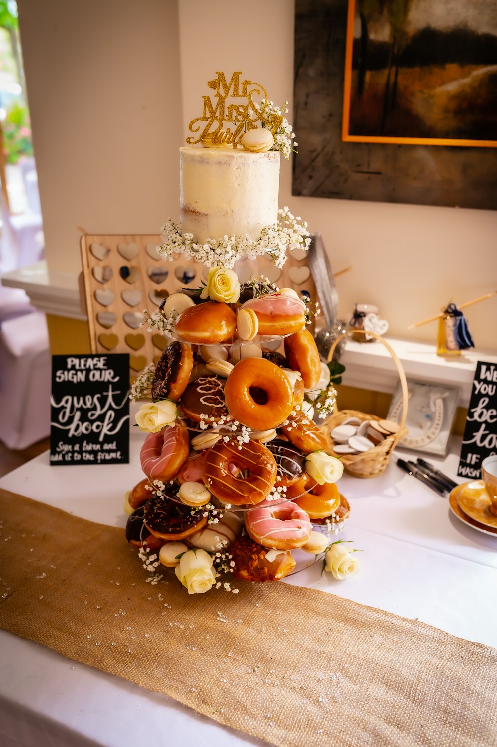 a wedding cake with donuts on top of it