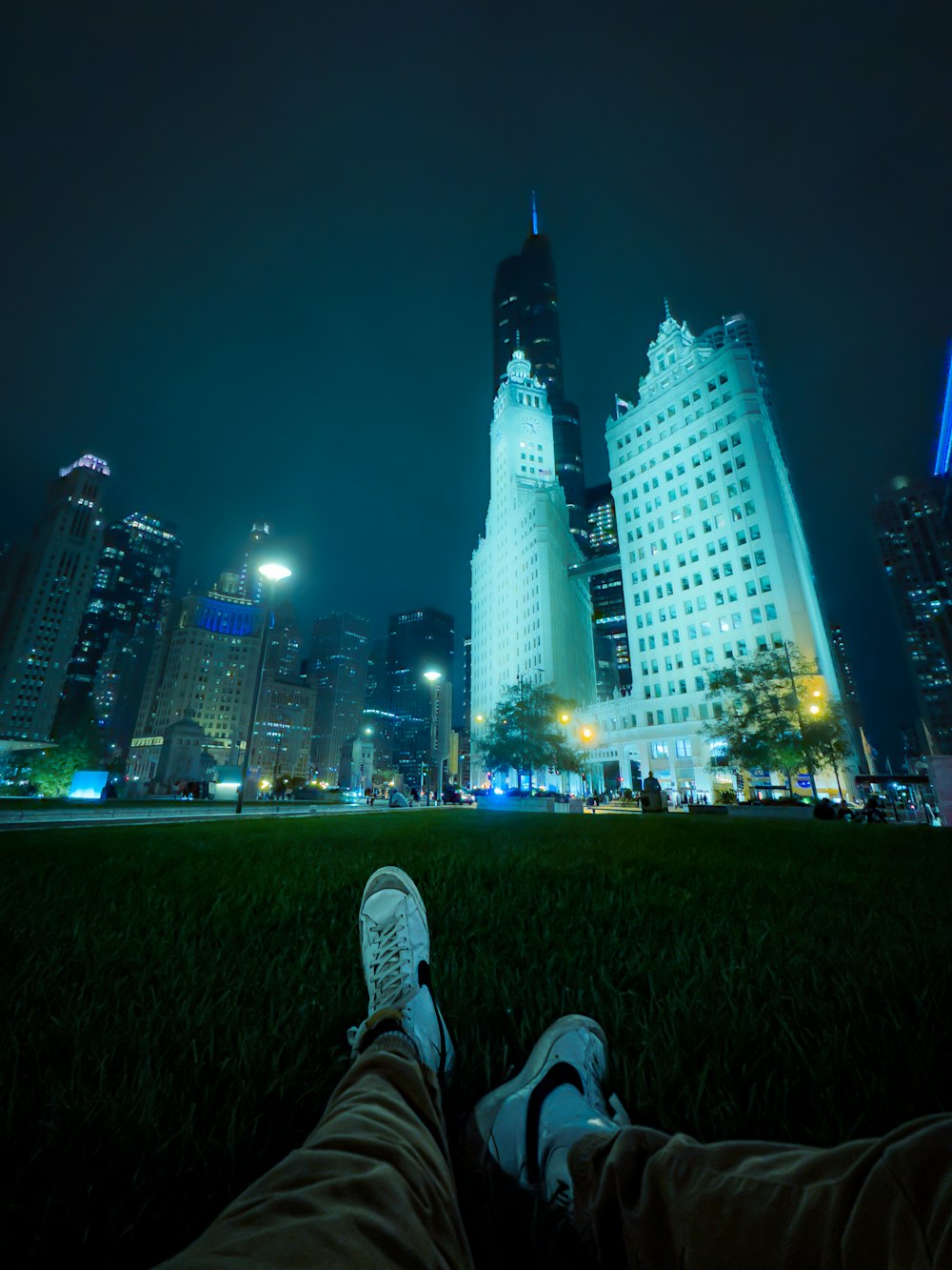 a person laying in the grass with their feet up