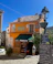 A smiling local business owner standing in front of their shop in Indre-et-Loire.