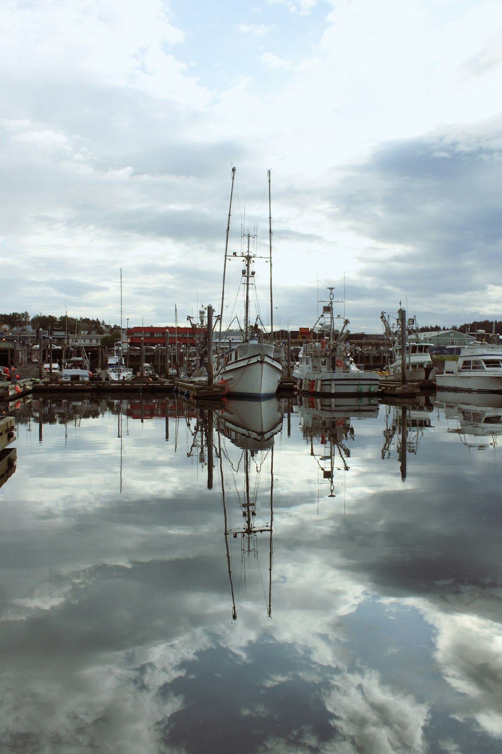 a harbor filled with lots of boats under a cloudy sky