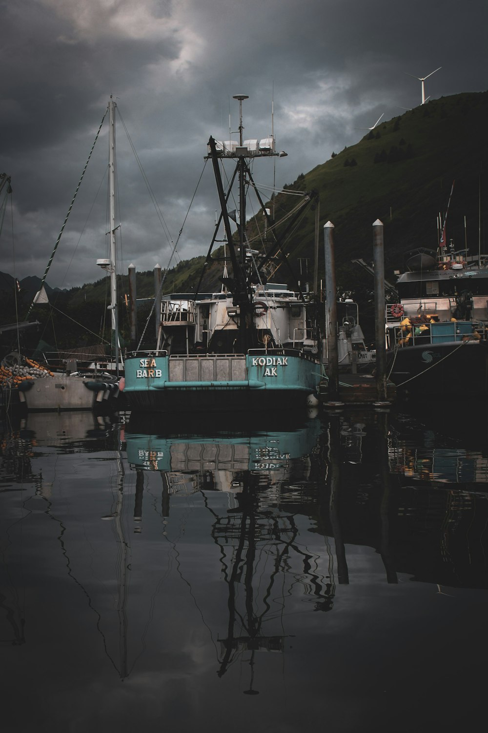 a boat is docked in a harbor on a cloudy day