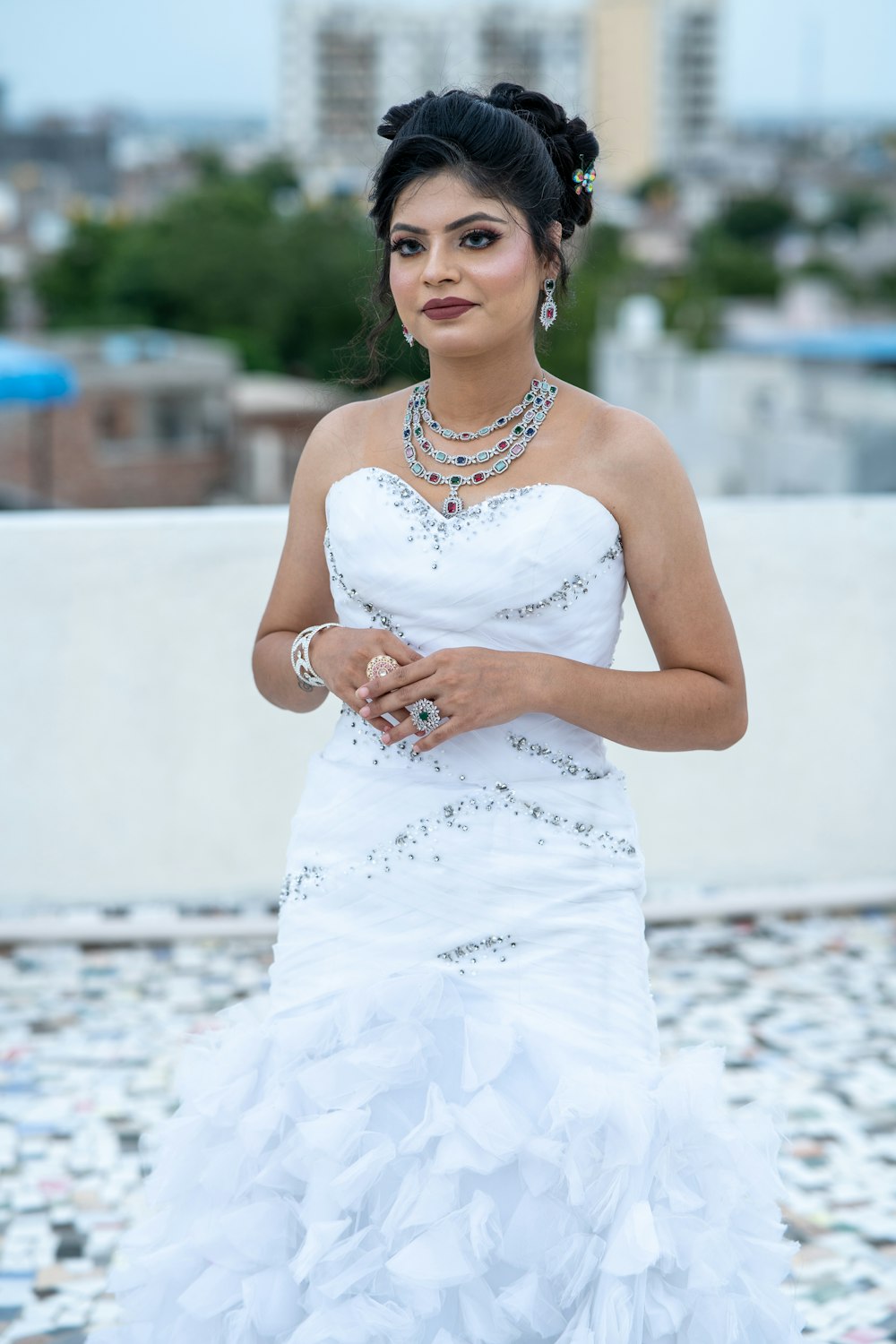 a woman in a white dress is posing for a picture