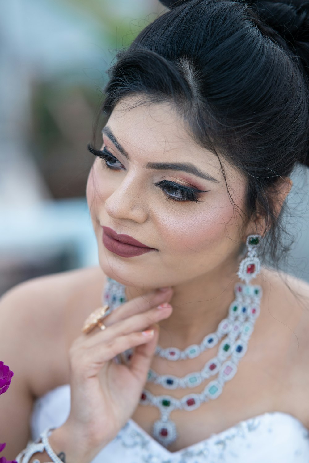 a woman in a white dress with a flower in her hair