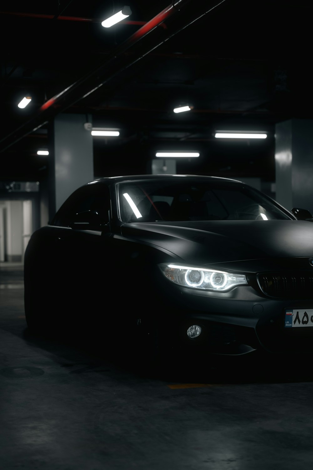 a black car parked in a parking garage