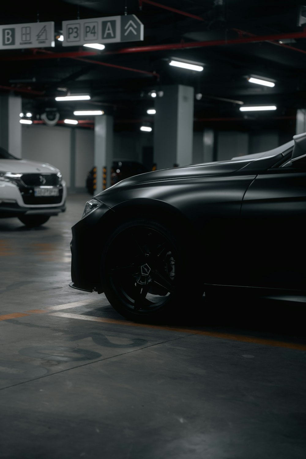 two cars are parked in a parking garage