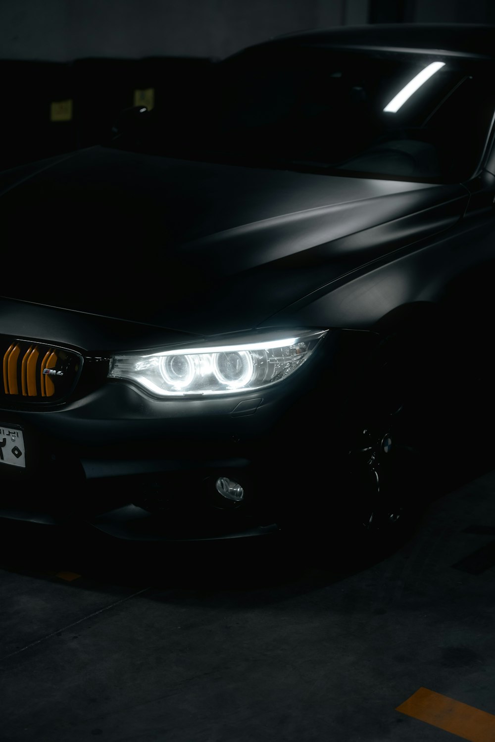 a black car parked in a parking garage