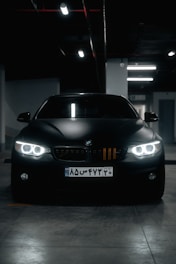 a black car parked in a parking garage