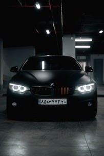 a black car parked in a parking garage
