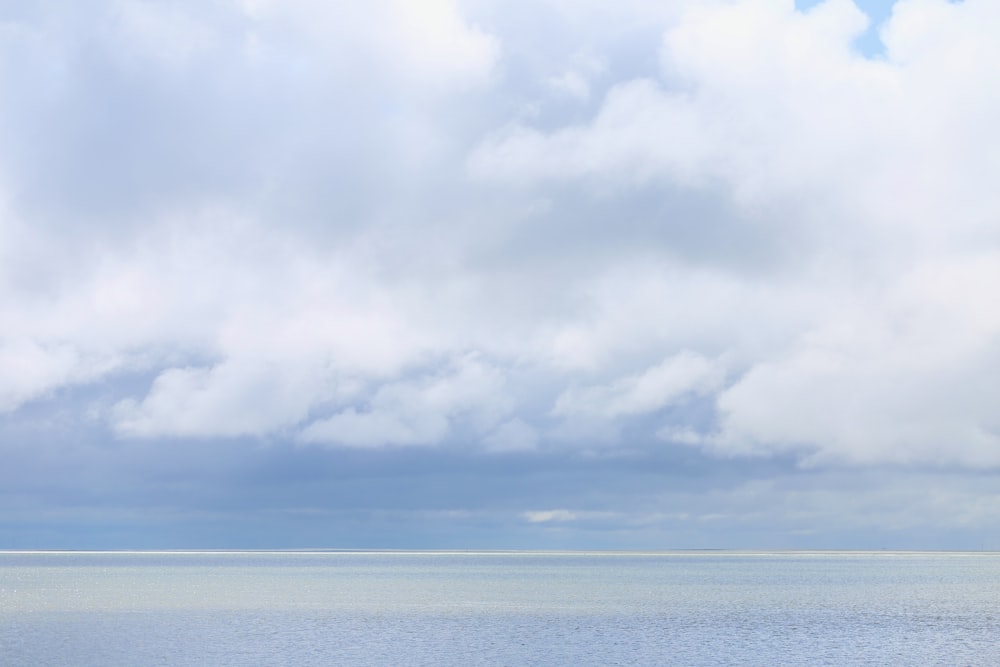 a large body of water sitting under a cloudy sky