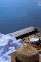 A peaceful outdoor setting with a picnic spread showcasing natural snacks and oils from pureharvest.