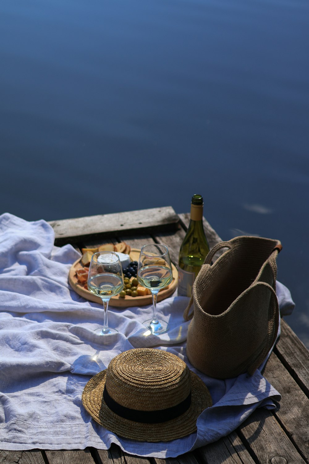 a table with a bottle of wine and a hat on it