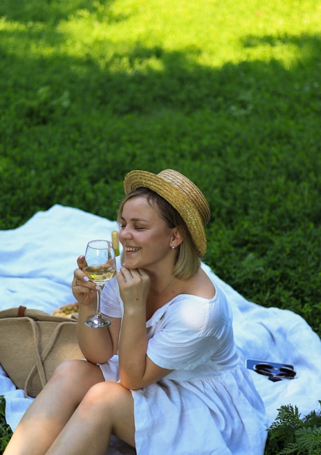 An influencer enjoying a luxurious picnic in a lush green park.