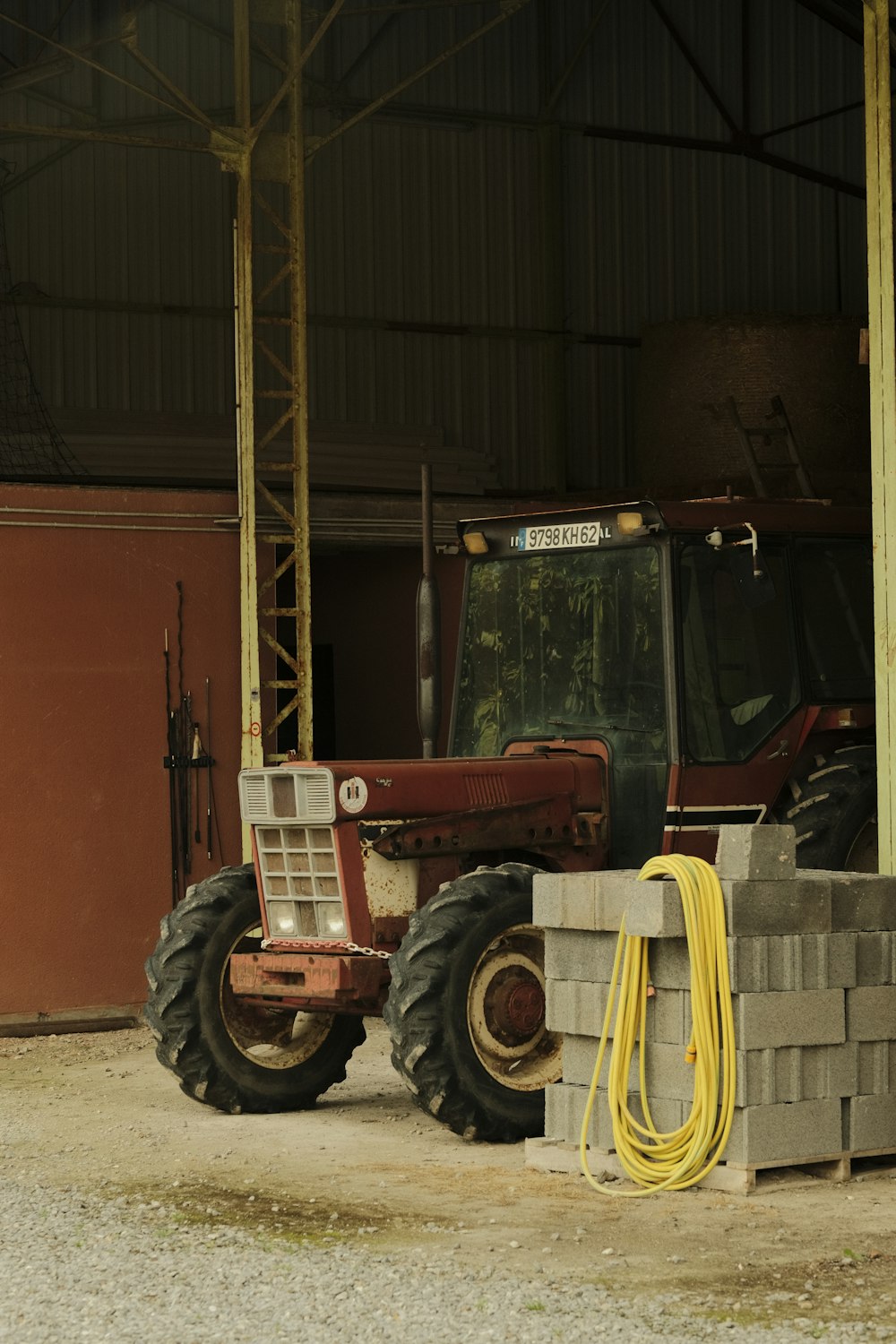 a tractor parked next to a pile of bricks