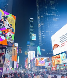 A vibrant outdoor billboard displaying a colorful advertisement in a busy urban area.