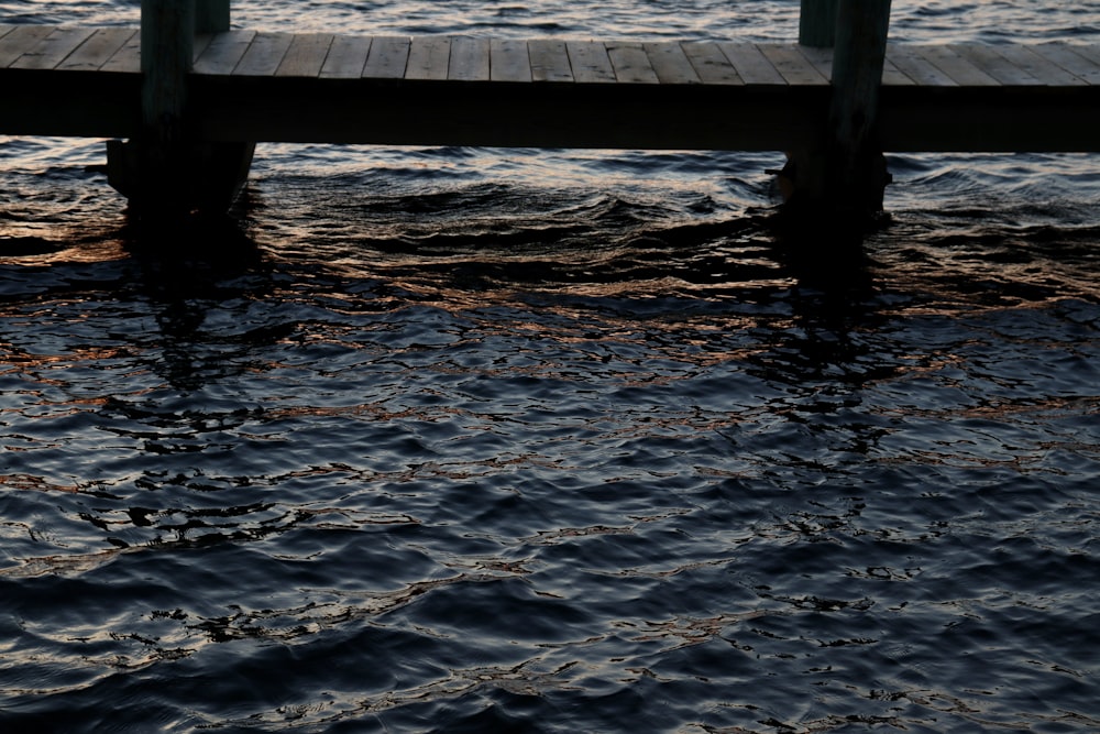 a wooden dock sitting on top of a body of water