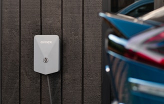 a car plugged in to a wall charger