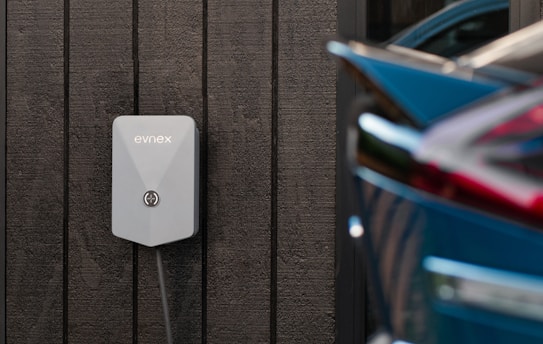 a car plugged in to a wall charger